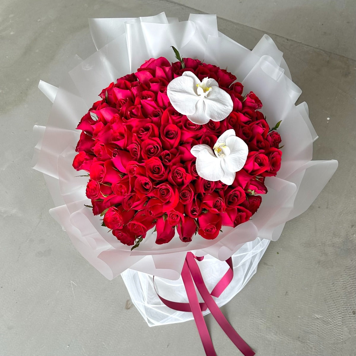 99 Roses - Glamour Tulle (Red in White Mesh with Phalaenopsis)